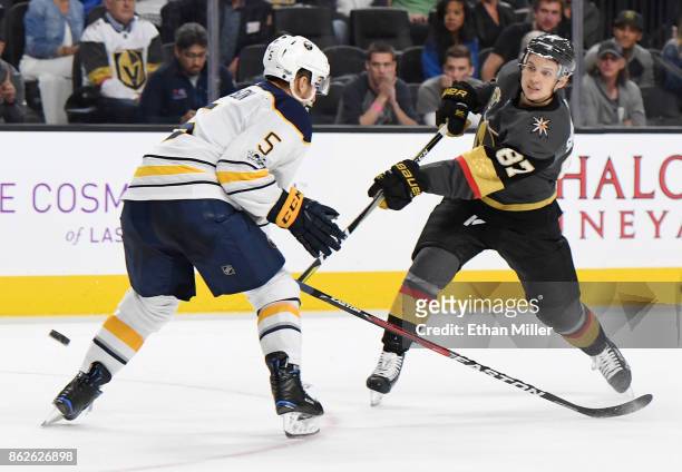Vadim Shipachyov of the Vegas Golden Knights takes a shot against Matt Tennyson of the Buffalo Sabres in overtime of their game at T-Mobile Arena on...