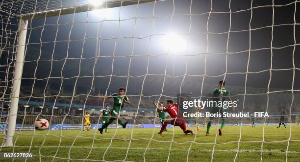 Seme Camara of Mali scores his team's third goal against goalkeeper Ali Ibadi of Iraq during the FIFA U-17 World Cup India 2017 Round of 16 match...