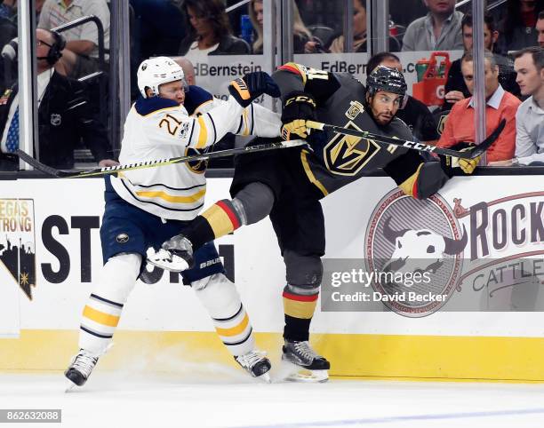 Kyle Okposo of the Buffalo Sabres goes to check Clayton Stoner of the Vegas Golden Knights at T-Mobile Arena on October 17, 2017 in Las Vegas,...