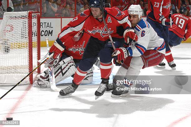 Tom Poti of the Washington Capitals trys to control the puck during Game Five of the Eastern Conference Quarterfinals of the 2009 NHL Stanley Cup...