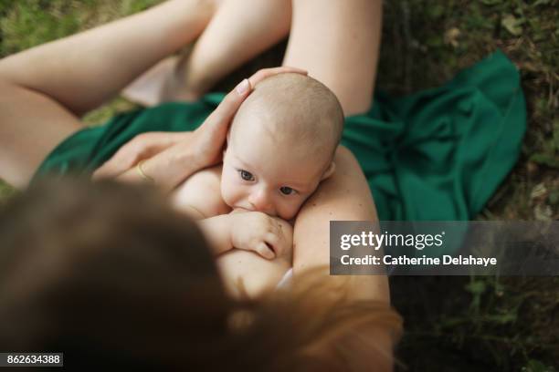 a mother breastfeeding her 3 months old baby boy - prima infanzia foto e immagini stock