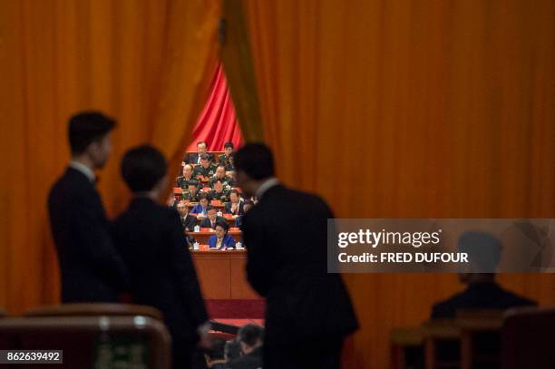 Chinese security guards look at military delegates during the speech of Chinese President Xi Jinping at the Communist Party's 19th Congress in...