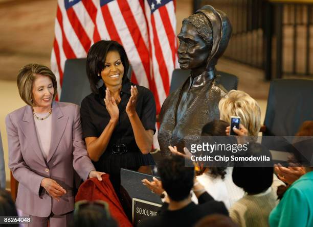 Speaker of the House Nancy Pelosi , and first lady Michelle Obama applaud after the unveiling of the bust of Sojourner Truth in the U.S. Capitol...