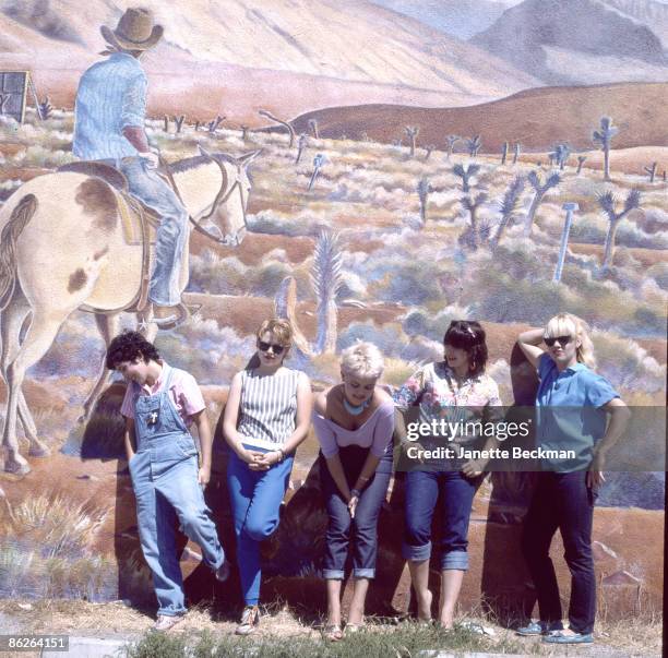 Portrait of music group the Go-Go's as they pose in front of a large, outdoor wall mural in Venice Beach, Los Angeles, California, 1979. Pictured...