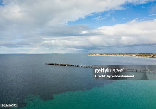 aerial view of the tumby bay jetty on a sunny day with a rainbow in the sky. - leafy seadragons stock-fotos und bilder