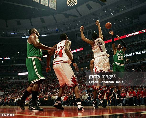Ray Allen of the Boston Celtics puts up a shot over Derrick Rose and Tyrus Thomas of the Chicago Bulls and teammate Glen Davis in Game Four of the...