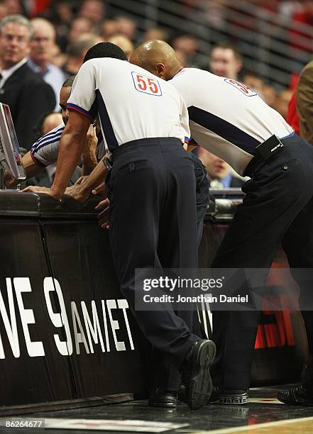 Referees Bill Kennedy, Marc Davis and Dan Crawford look at a replay of an altercation between the Chicago Bulls and the Boston Celtics in Game Four...