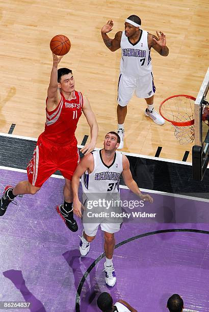 Yao Ming of the Houston Rockets hooks a shot over Spencer Hawes of the Sacramento Kings during the game on April 9, 2009 at Arco Arena in Sacramento,...