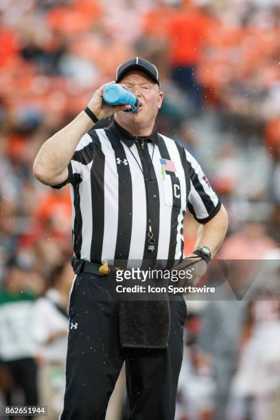 Center judge Brett Denker gets a drink of water during a timeout in the second half of a game between the Ohio Bobcats and the Bowling Green Falcons...