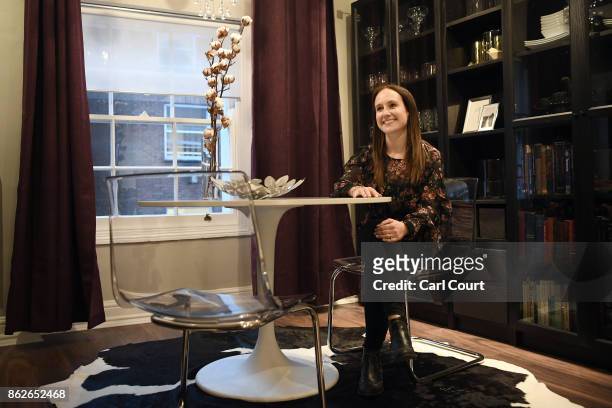 Member of staff poses for a photograph in the 'Noughties Room' of the IKEA house on October 17, 2017 in London, England. The room is in the 'IKEA...