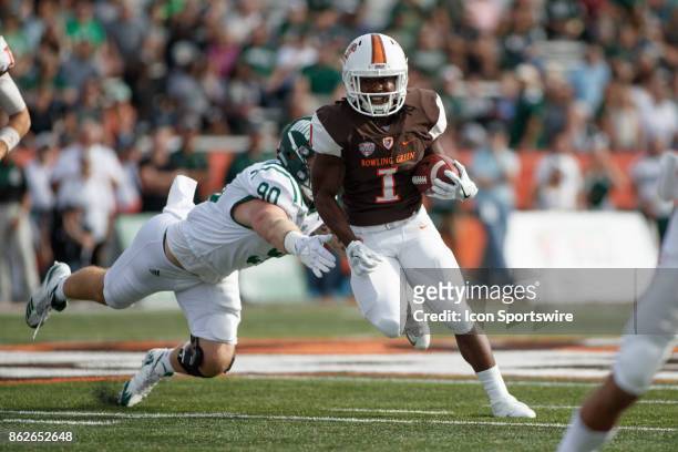 Bowling Green Falcons running back Josh Cleveland runs the ball while Ohio Bobcats defensive end Trent Smart misses a tackle in the first half of a...