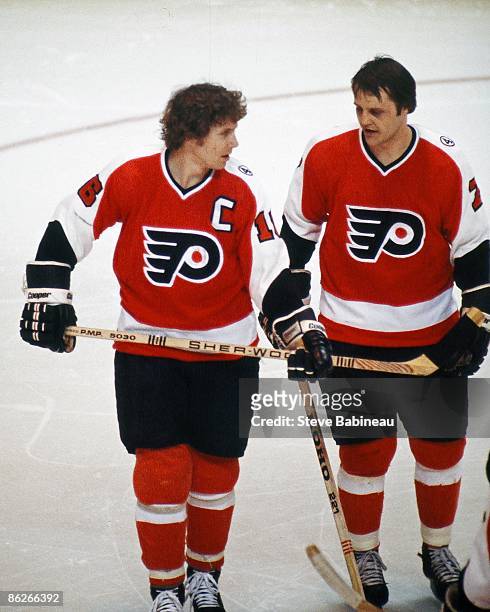 Bobby Clarke and Bill Barber of the Philadelphia Flyers talk during break in play against the Boston Bruins at Boston Garden.