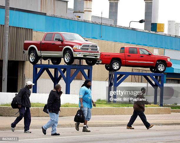 Chrysler workers exit from the Chrysler Warren Truck Plant April 28, 2009 in Warren, Michigan. Chrysler has until April 30th to meet the conditions...