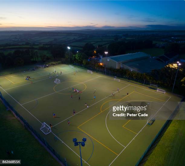 football game at night - aerial football stock-fotos und bilder