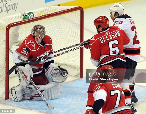 Goalie Cam Ward of the Carolina Hurricanes blocks the shot of David Clarkson of the New Jersey Devils as Tim Gleason of the Carolina Hurricanes comes...