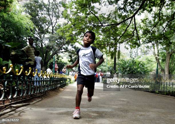 Indian child athlete Budhia Singh runs in the grounds of the Press Club in Bangalore, 27 May 2006. The child from the eastern Indian state of Orissa...