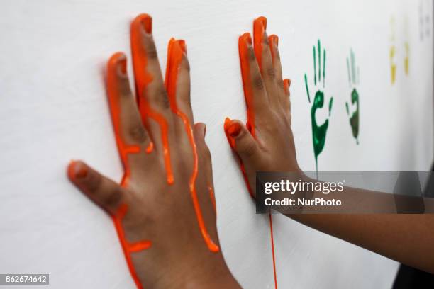 Students shown their colored hands before practicing a handwashing with soap properly, in commemoration of Global Handwashing Day commemorated every...