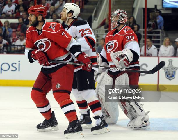 Defenseman Niclas Wallin of the Carolina Hurricanes, David Clarkson of the New Jersey Devils and goalie Cam Ward of the Carolina Hurricanes stack up...