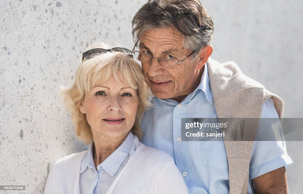 Portrait of a Senior Couple in Front a Wall