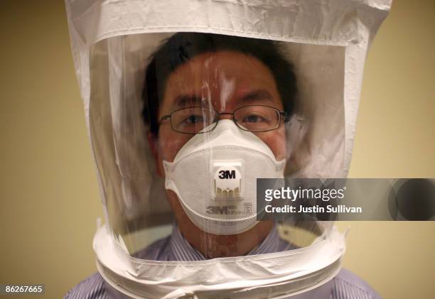 Doctor wears a hood as he tests the seal of an N95 respiratory maske during a training at the La Clinica San Antonio Neighborhood Health Center April...