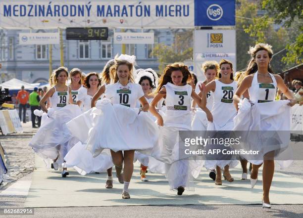 Women in wedding dress compete a one-hundred metres during the 83th Peace Marathon 01 October 2006 in eastern Slovakia city Kosice. AFP PHOTO/SAMUEL...