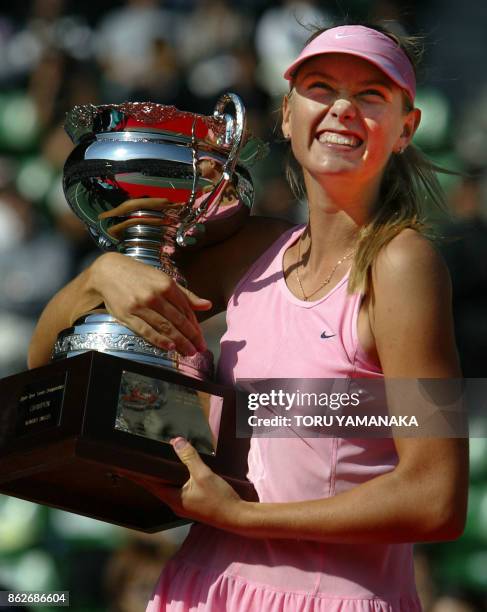 Maria Sharapova of Russia smiles as she holds the trophy during award ceremony for women's singles after the final match against Aniko Kapros of...