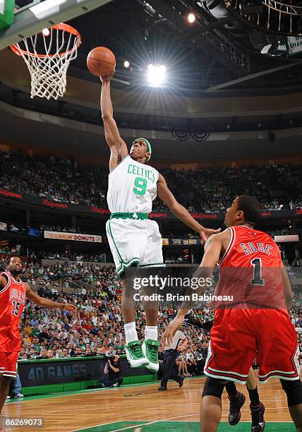 Rajon Rondo of the Boston Celtics dunks the ball against Derrick Rose of the Chicago Bulls in Game Five of the Eastern Conference Quarterfinals...