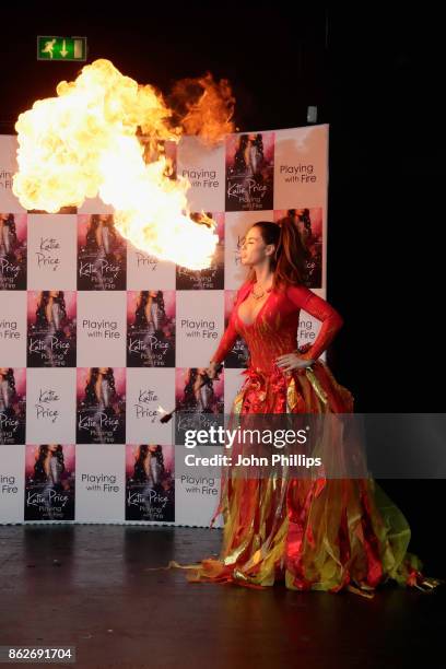 Katie Price spits fire at a photocall for her new novel 'Playing With Fire' at The Worx Studio's on October 17, 2017 in London, England.