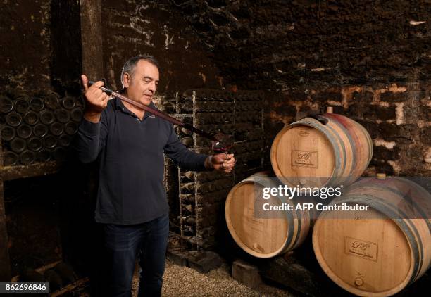 Winemaker Dominique Gallois poses in his cellar, on October 11, 2017 in Gevrey-Chambertin. / AFP PHOTO / ERIC FEFERBERG