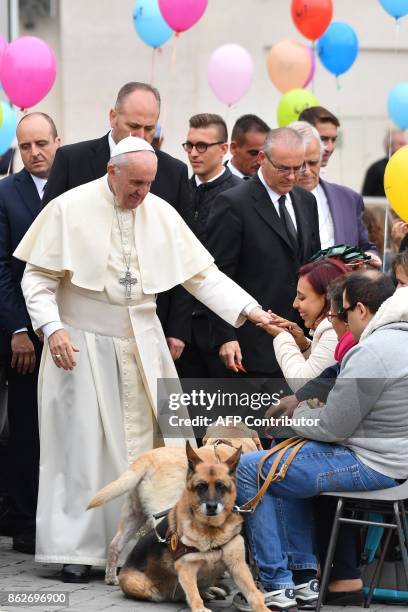 Pope Francis greets a group of partially sighted and blind people during his weekly general audience at St Peter's square on October 18 in Vatican. /...