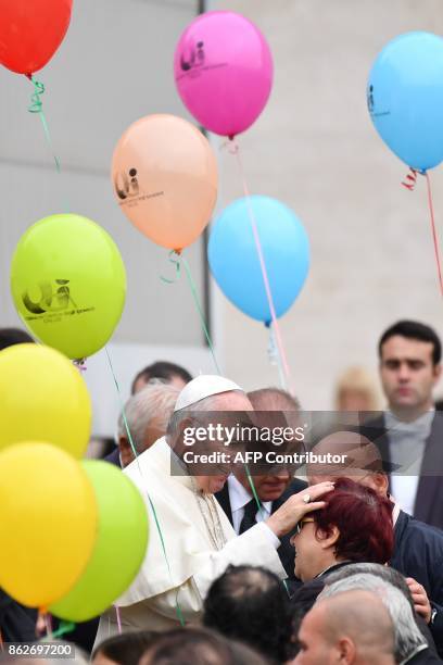 Pope Francis greets a group of partially sighted and blind people during his weekly general audience at St Peter's square on October 18 in Vatican. /...