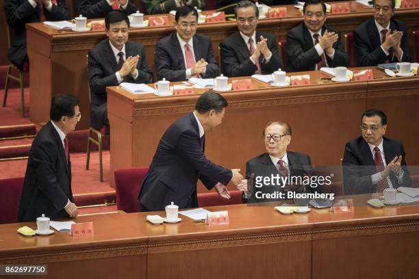 Xi Jinping, China's president, center left, shakes hands with Jiang Zemin, China's former president, after delivering his speech as Li Keqiang,...
