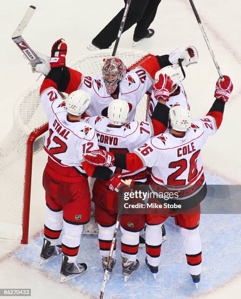 Cam Ward of the Carolina Hurricanes celebrates with teammates Eric Staal, Erik Cole and Joe Corvo after defeating the New Jersey Devils 4-3 in Game...