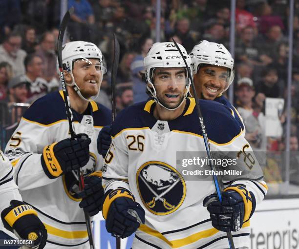 Matt Tennyson, Matt Moulson and Evander Kane of the Buffalo Sabres celebrate after a first-period goal scored by Ryan O'Reilly · #90 against the...