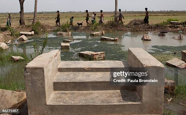The remains of a house surrounded by debris from Cyclone Nargis is seen on April 27, 2009 in the Irrawady delta village of Pyinbogyi, Myanmar . A...