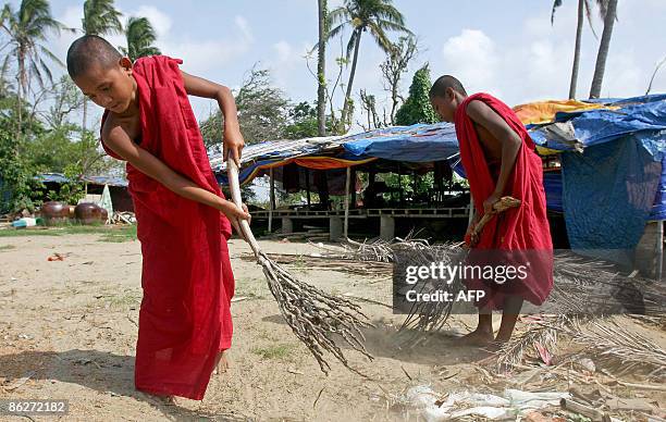 By Claire TRUSCOTT In this picture taken on April 22, 2009 at Pyinsalu town, in Myanmar's Irrawaddy delta, young Buddhist novices clean an area...