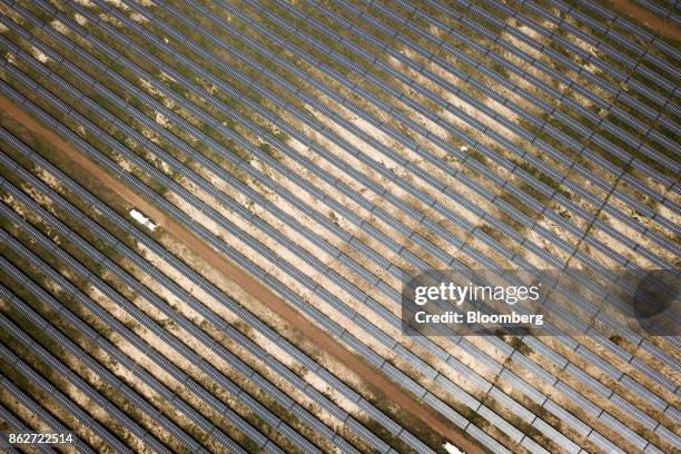 Photovoltaic solar panels sit in an array at the Senergy Santhiou Mekhe PV solar plant in this aerial photograph taken in Thies, Senegal, on Monday,...