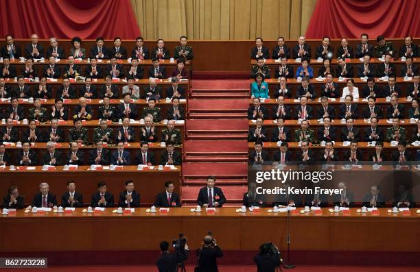 Chinese President Xi Jinping, bottom center, is applauded by senior members of the government after his speech at the opening session of the 19th...