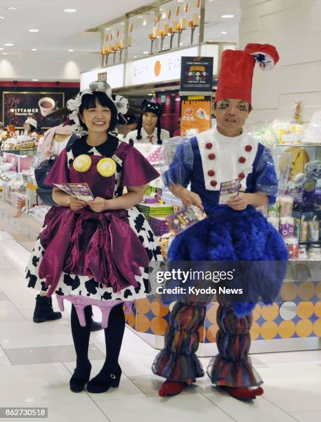 Store clerks wearing Halloween costumes pose for a photo at a Daimaru department store in Osaka on Oct. 11, 2017. ==Kyodo