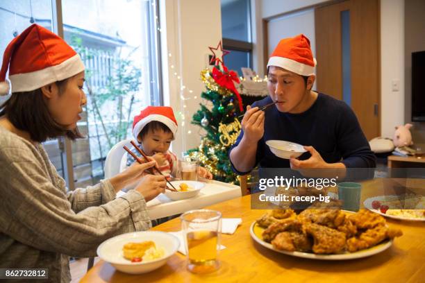 japanese family having christmas lunch - fried chicken imagens e fotografias de stock