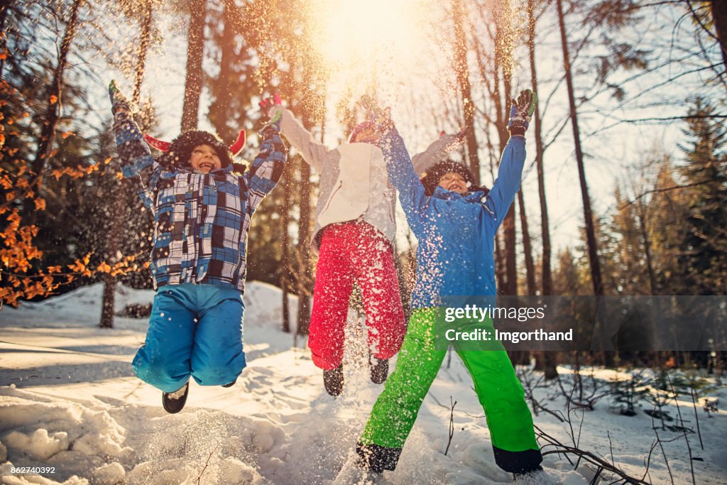 Kids jumping with joy on winter day