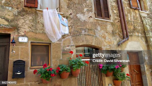 July 22: Geraniums and washing share a wall on July 22 , 2015 in the medieval village of Pitigliano, in the Grosseto province of Tuscany, Italy....