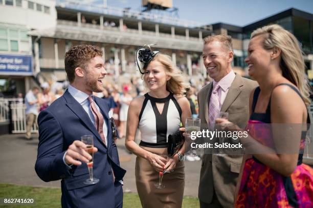 two couples enjoying a drink - newcastle races stock pictures, royalty-free photos & images