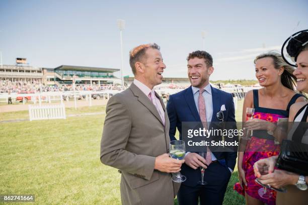 two couples enjoying a drink - newcastle races stock pictures, royalty-free photos & images