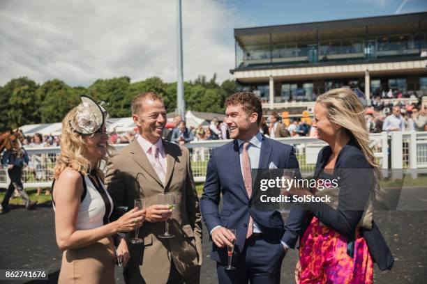 two couples enjoying a drink - newcastle races stock pictures, royalty-free photos & images