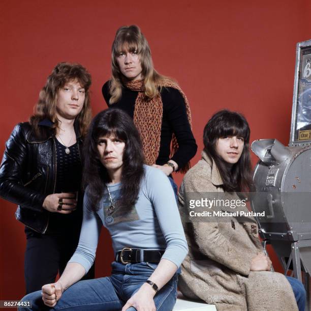 British glam rock band Sweet pose with a Mutoscope in London, 13th January 1976. They are Steve Priest, Andy Scott, Brian Connolly and Mick Tucker.