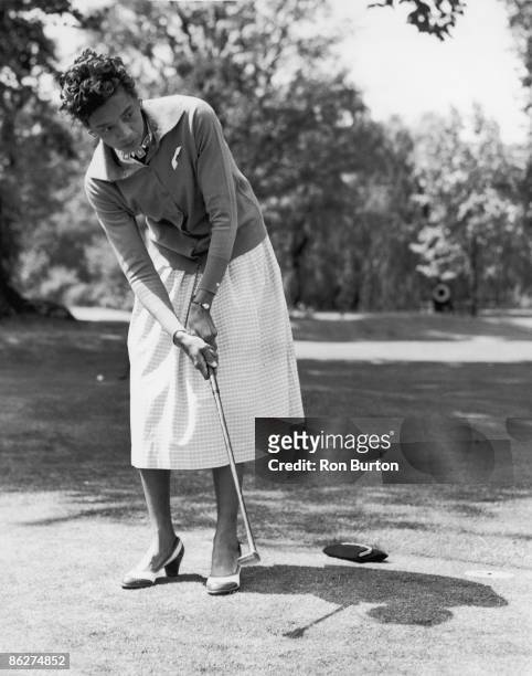 American tennis player Althea Gibson enjoys a round of golf at the reception for overseas entrants in the Wimbledon Lawn Tennis Championships, held...