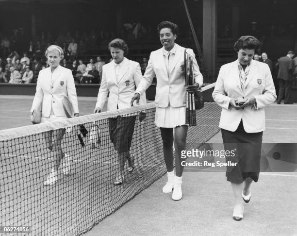 Tennis players Shirley Bloomer of Great Britain, Margaret Osborne duPont and Althea Gibson of the USA, and England Captain Mary Halford, walk onto...