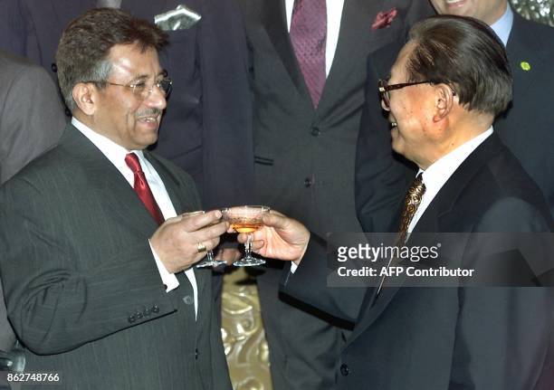 Pakistan President General Pervez Musharraf toasts with Chinese President Jiang Zemin, after a signing ceremony of seven trade agreements between the...