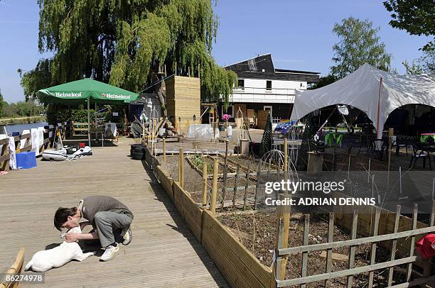 Visitor to Raven's Ait kisses a dog in the garden area of the island near Kingston-Upon Thames, west of London, on April 24, 2009. A bucolic,...